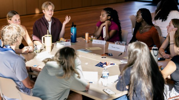 A group of students in discussion at their table during a CCF convening