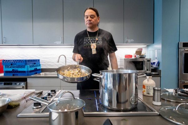 Chef Sean Sherman holding steamy pan in demonstration