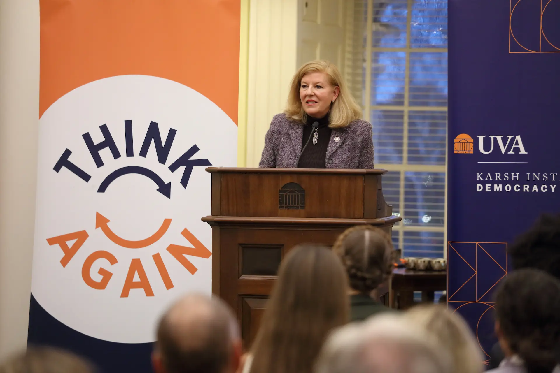 A woman speaking at a podium at a Karsh Institute event