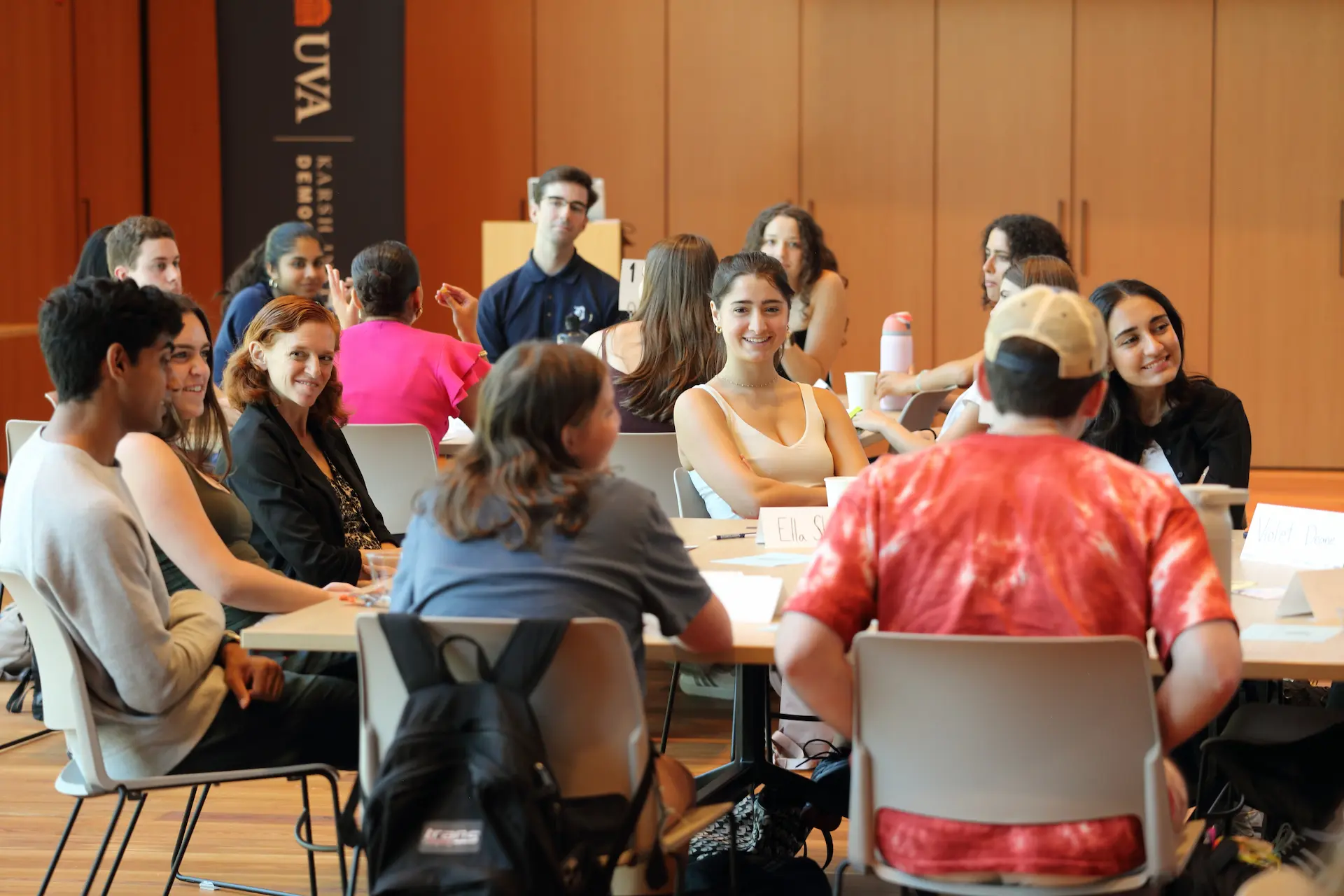 A group of student participants talking around a table