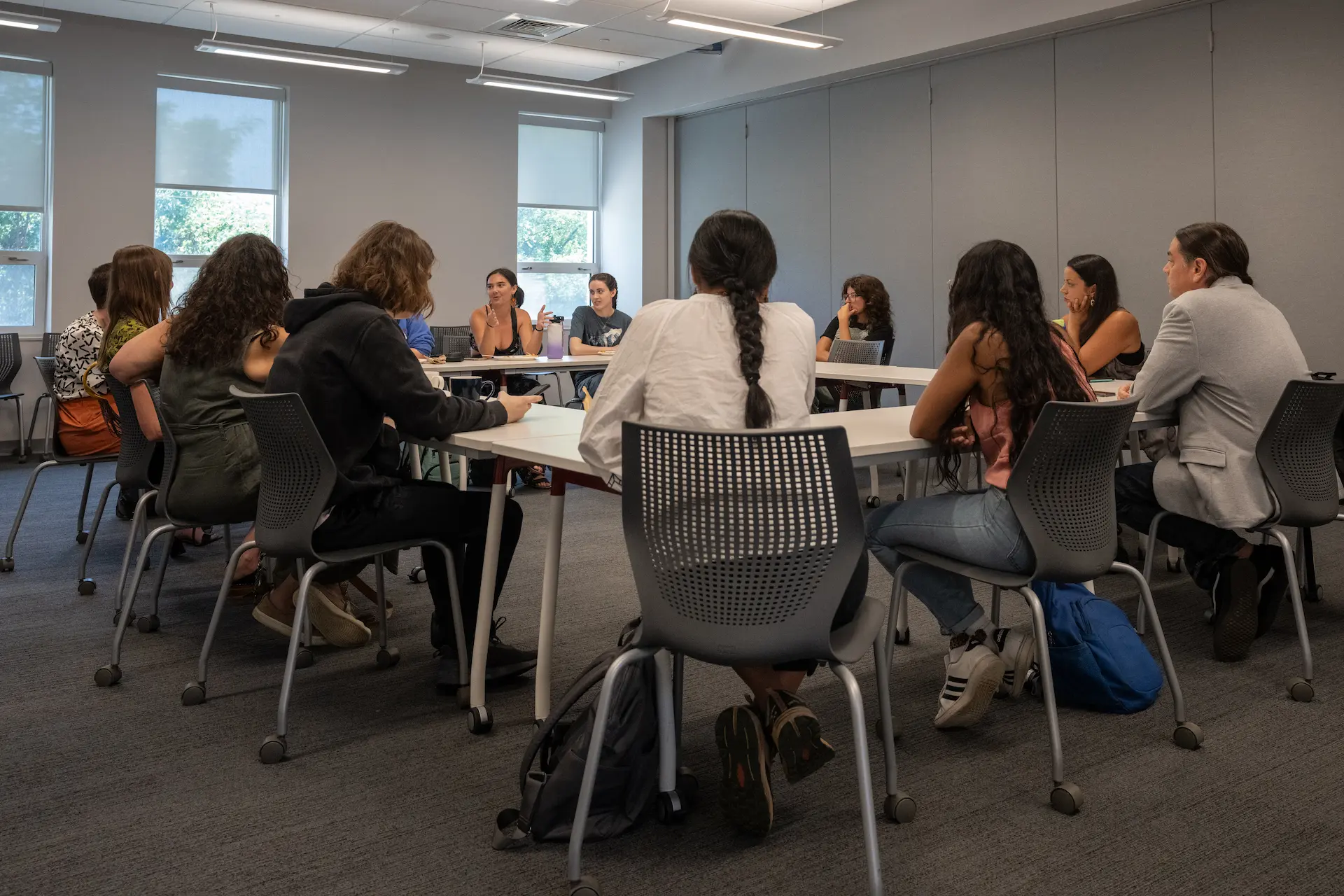 Many students discussing around a table