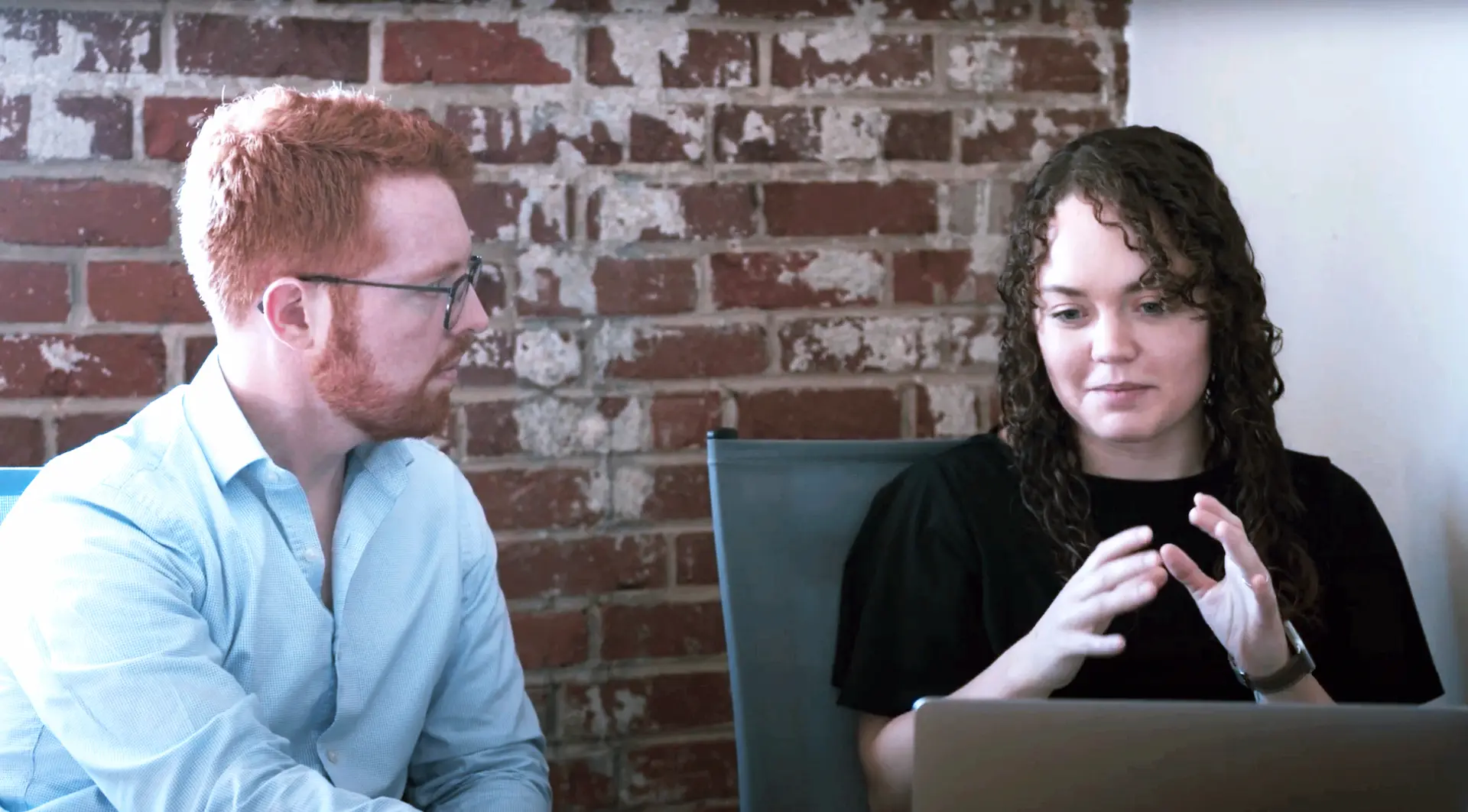 Two interns standing at a D360 table